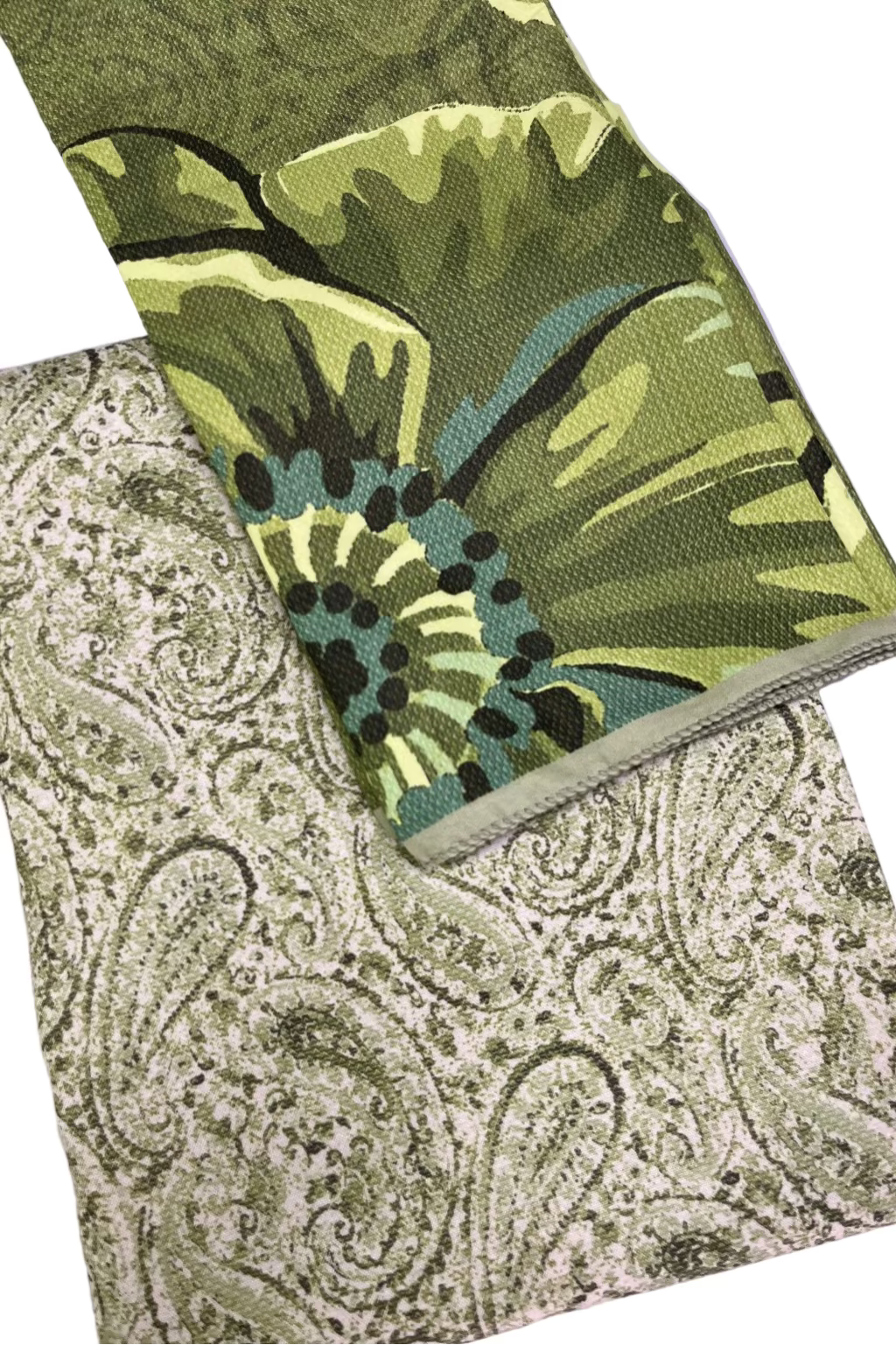 Two patterned cloths, one green with abstract design and one paisley, on a white background.