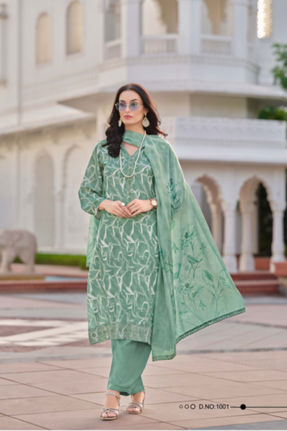 Woman wearing a green traditional outfit with a white building in the background