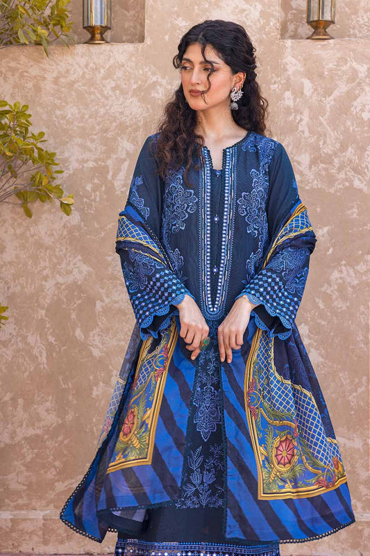 A woman wearing a traditional blue and multicolor salwar kameez suit with floral and geometric digital printed design.