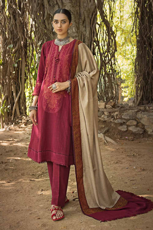 A woman wearing a red and beige unstitched embroidered pashmina salwar kameez suit with a dupatta, standing outdoors.